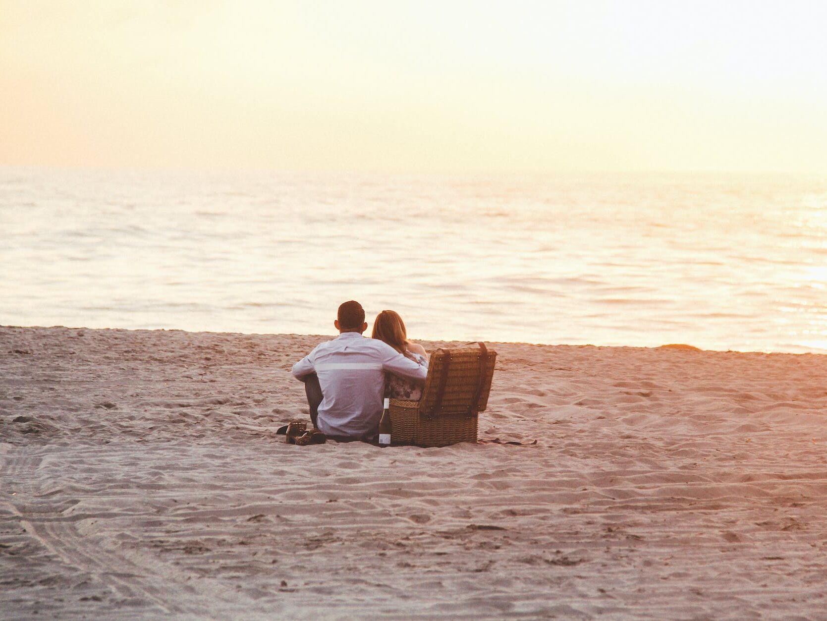 couple at beach near cooler