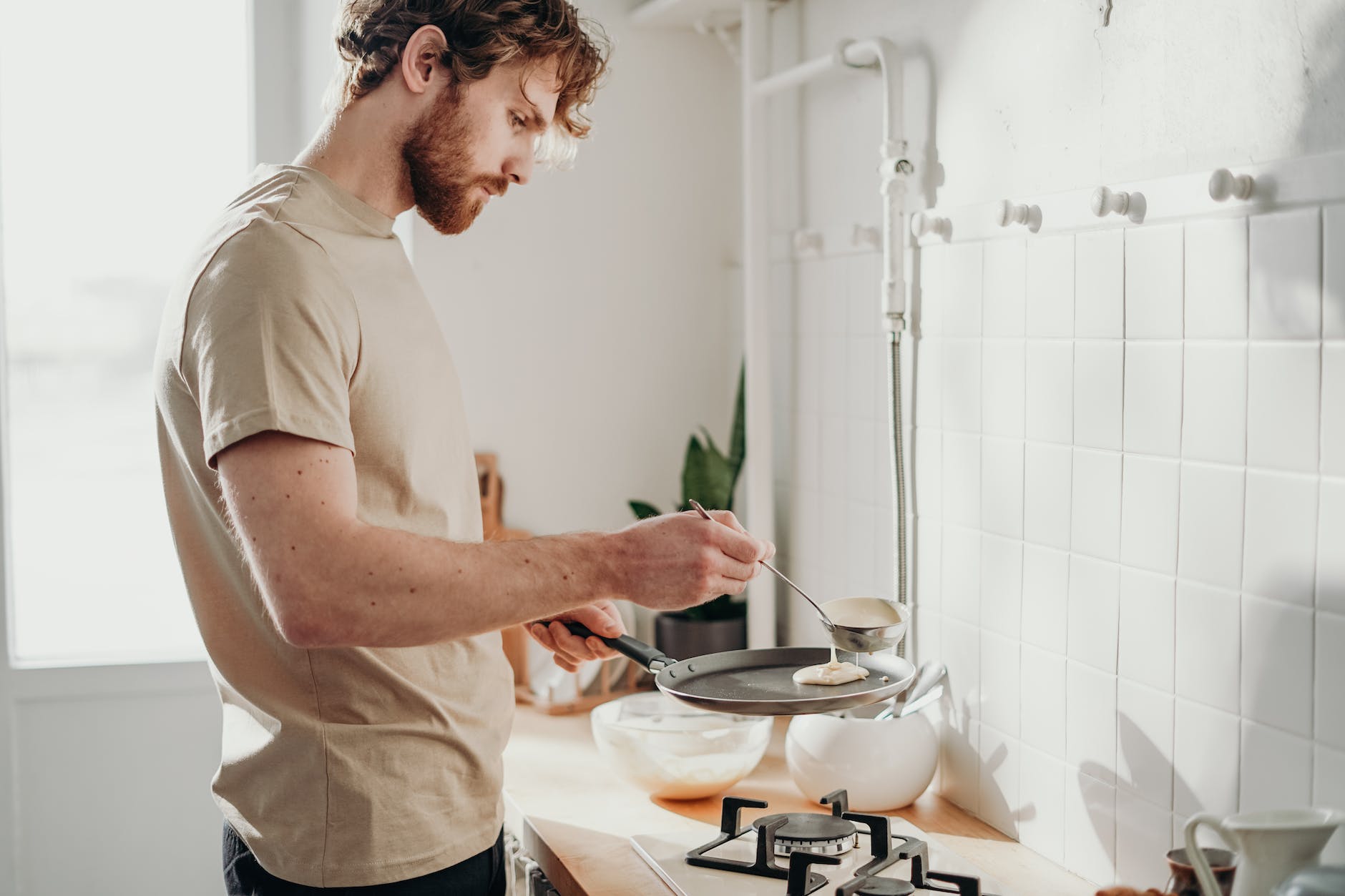 man cooking pancakes